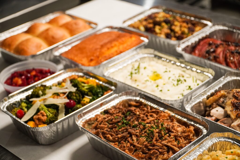 The buffet of food in silver tin trays at the family holiday party