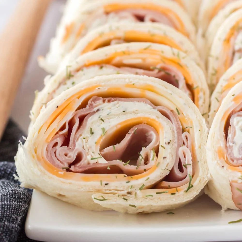 Ham and cheese rolled up in a wrap is a great lunch for picky eaters and simple to make