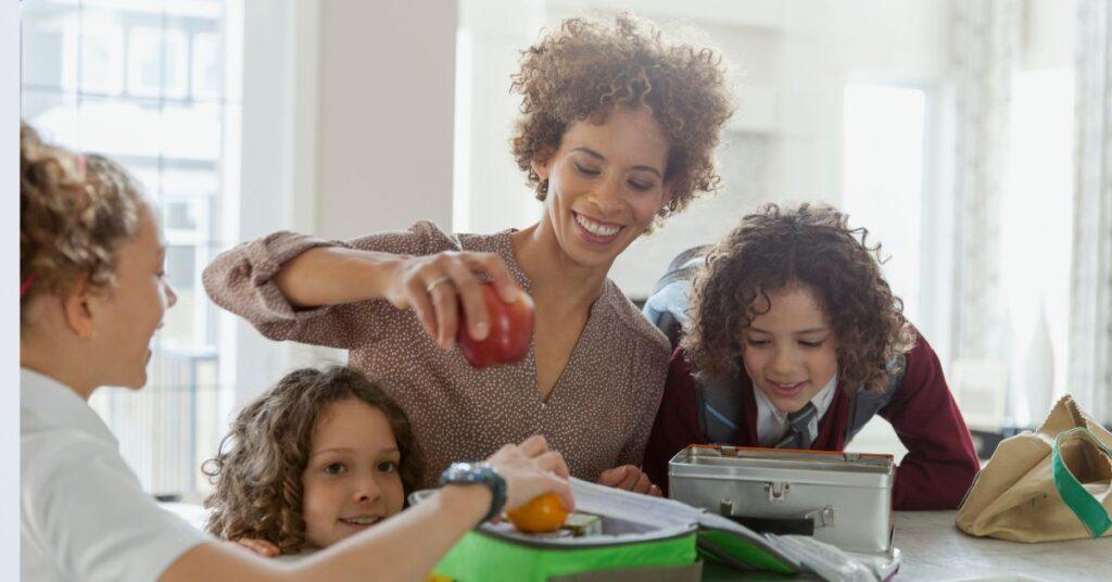 Mother and children packing school lunches